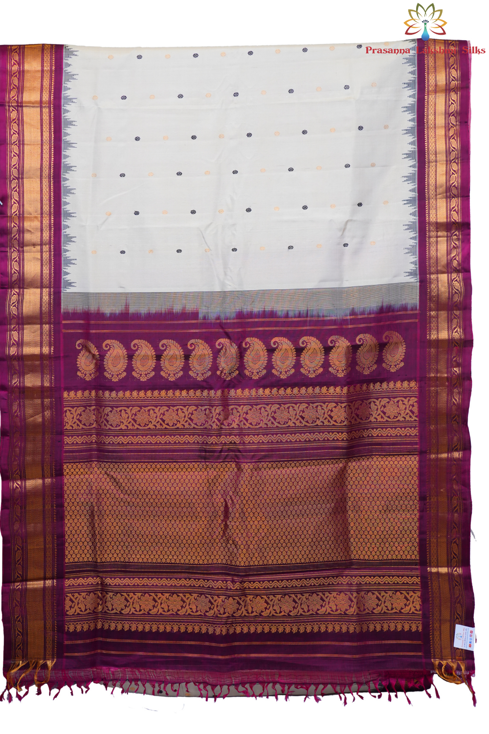 Traditional Gadwal silk saree featuring zari-woven borders and contrast blouse.