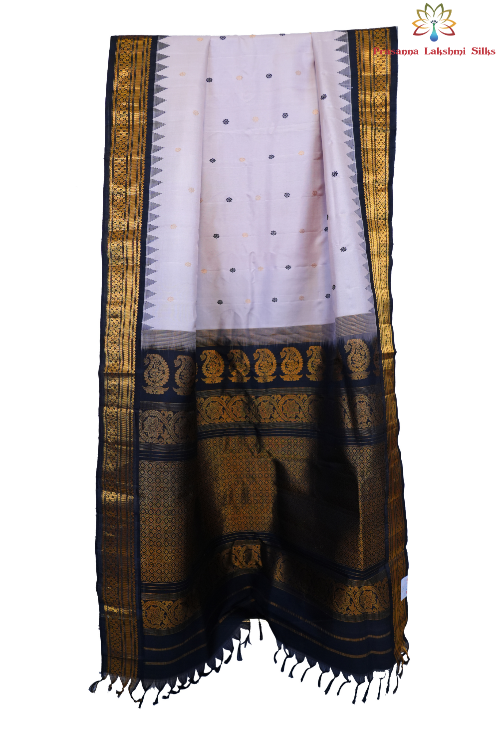 Traditional Gadwal silk saree featuring zari-woven borders and contrast blouse.
