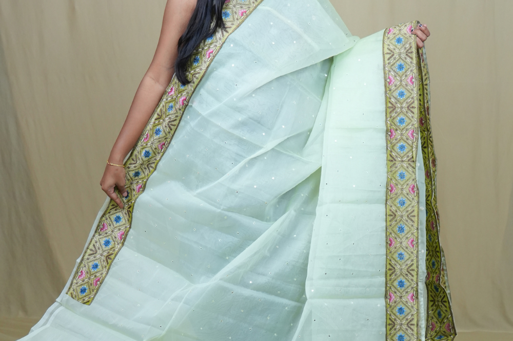 Traditional lightweight Organza Saree suitable for weddings and festive occasions with mirror work.