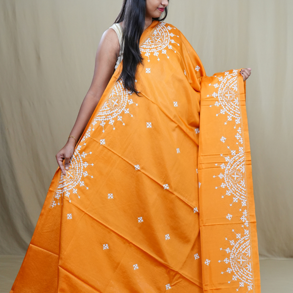 Traditional semi silk saree featuring beautiful hand Kutch work borders and artistic design.
