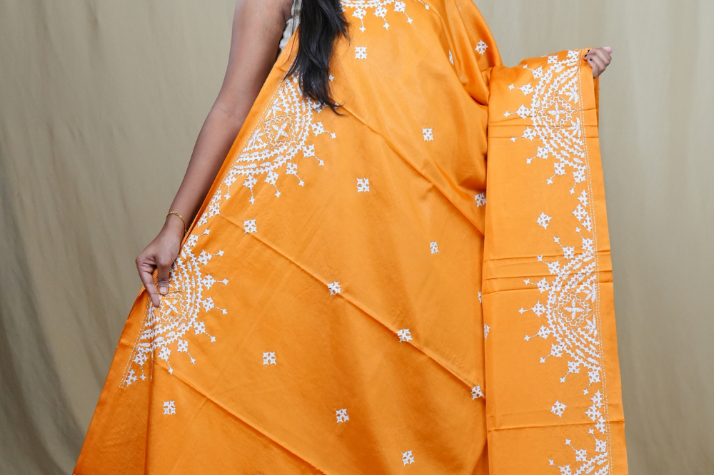 Traditional semi silk saree featuring beautiful hand Kutch work borders and artistic design.

