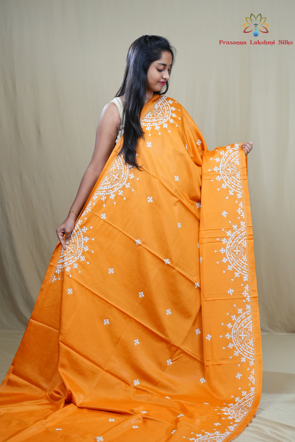 Traditional semi silk saree featuring beautiful hand Kutch work borders and artistic design.
