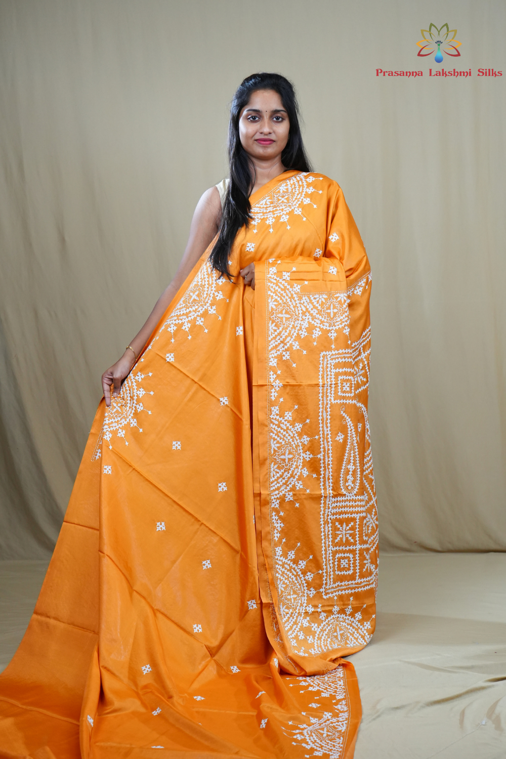 Semi Bangalore Silk Saree with all-over Kutch work motifs and rich embroidered pallu.
