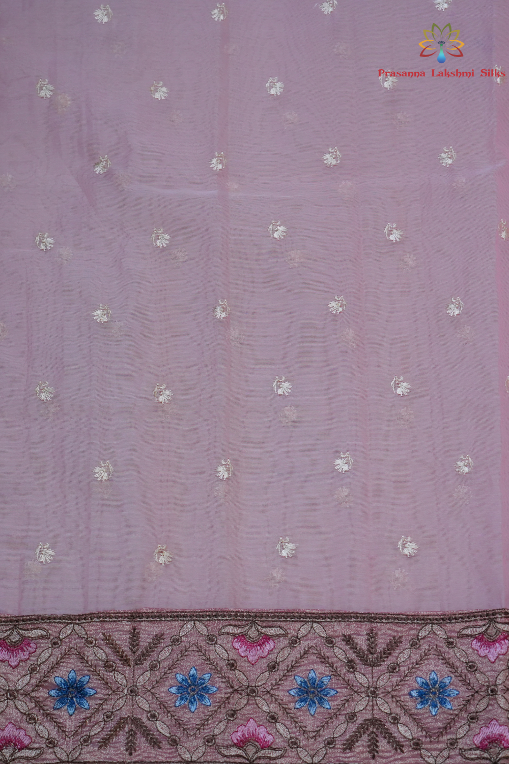 Elegant ethnic organza saree featuring floral pallu design and matching running blouse.

