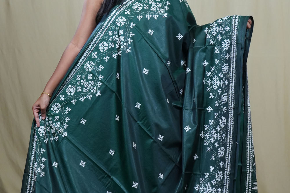 Traditional semi silk saree featuring beautiful hand Kutch work borders and artistic design.
