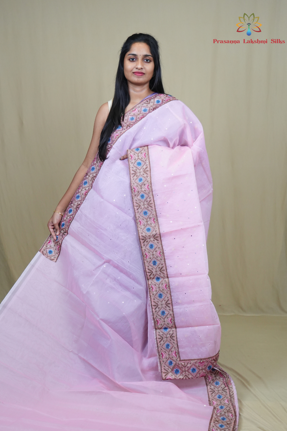 Organza Saree with all-over small mirror work and thread-woven tissue floral borders.

