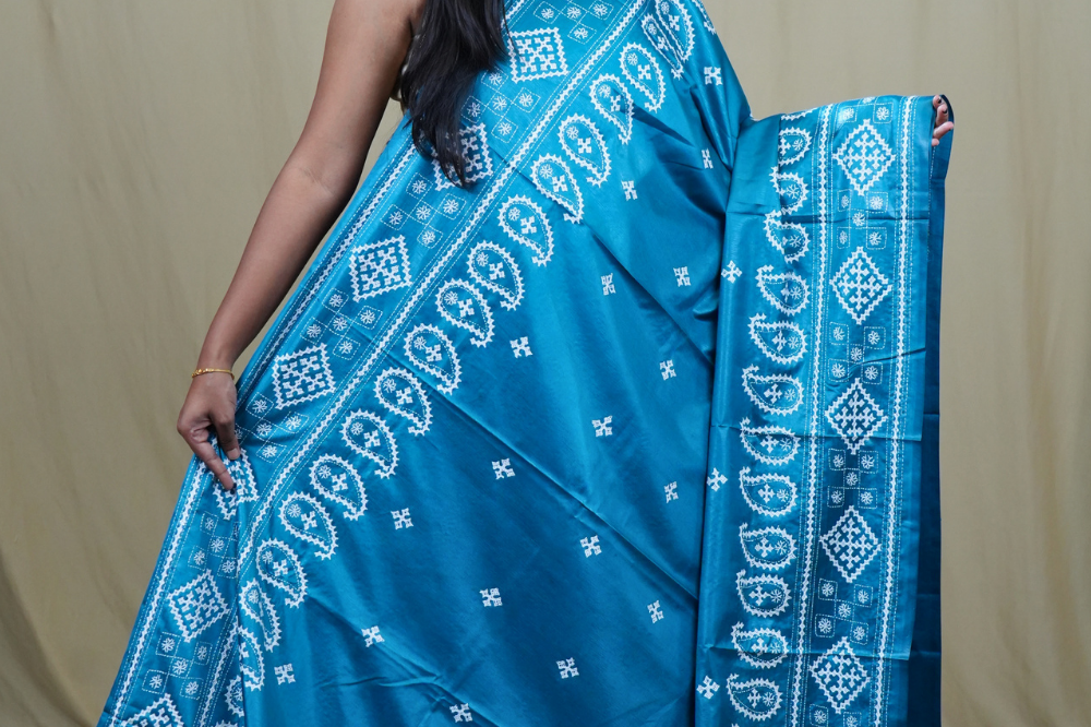Traditional semi silk saree featuring beautiful hand Kutch work borders and artistic design.
