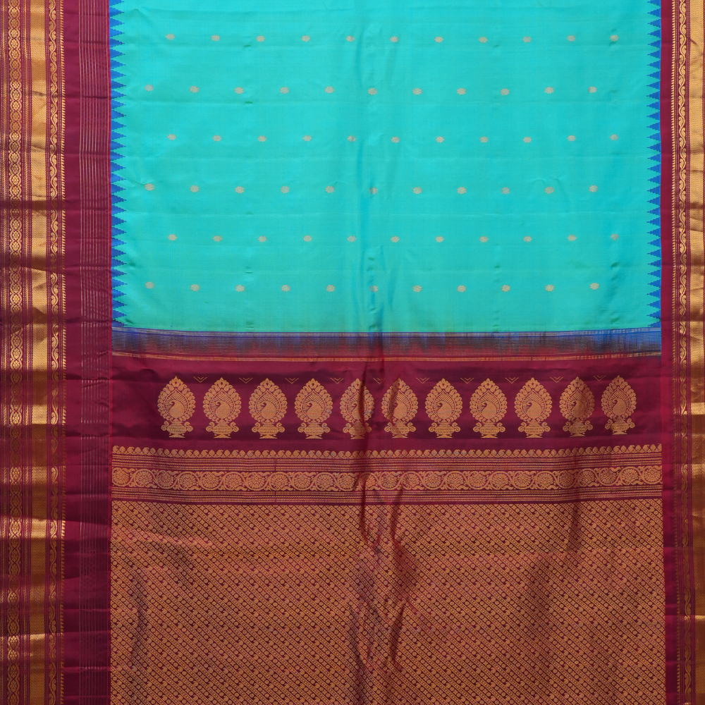 Handloom Gadwal pure silk saree with intricate small zari motifs and rich woven pallu.
