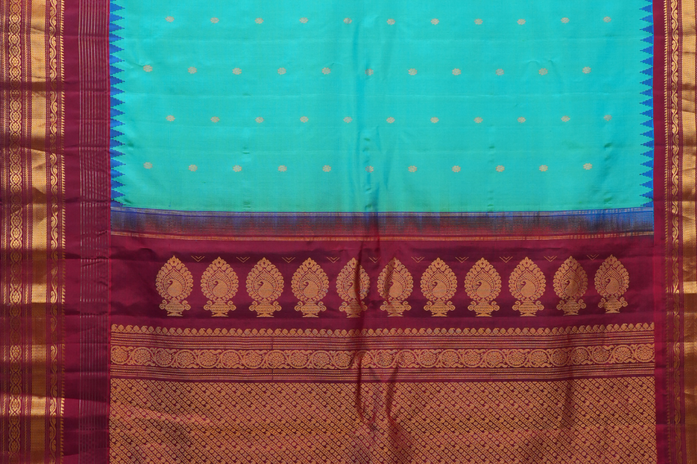 Handloom Gadwal pure silk saree with intricate small zari motifs and rich woven pallu.
