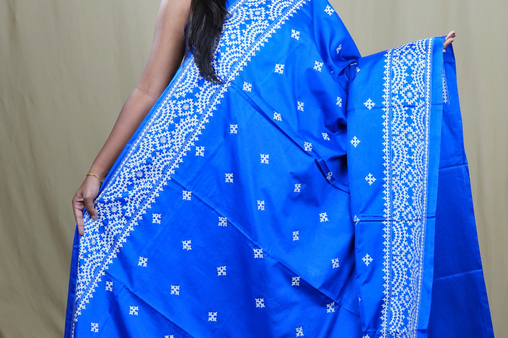 Traditional semi silk saree featuring beautiful hand Kutch work borders and artistic design.
