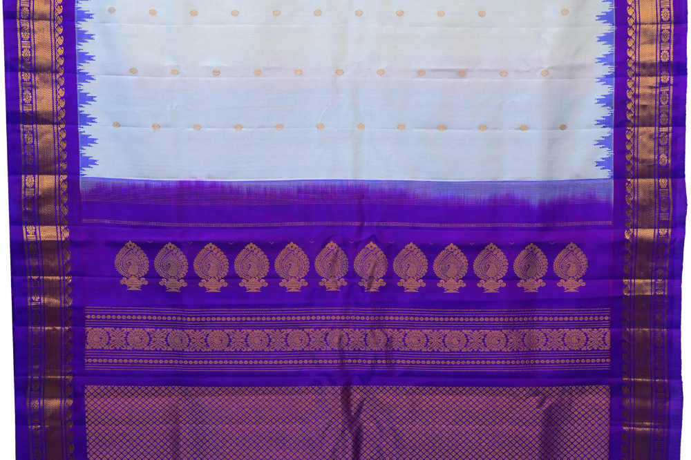 Handloom Gadwal pure silk saree with intricate small zari motifs and rich woven pallu.
