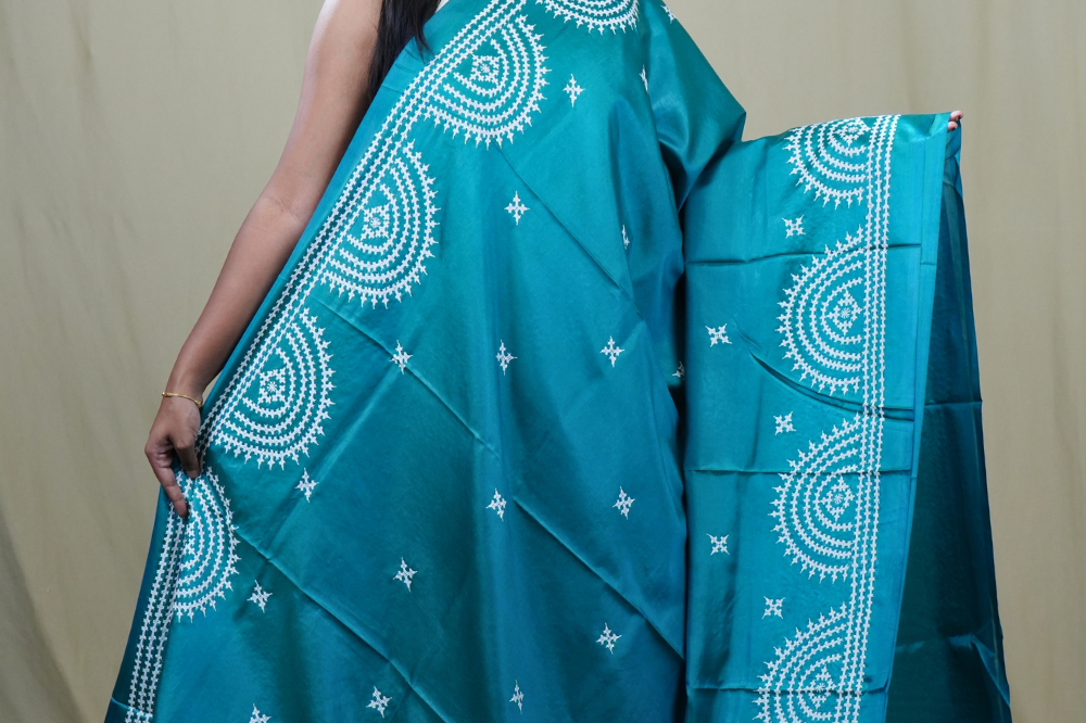 Traditional semi silk saree featuring beautiful hand Kutch work borders and artistic design.
