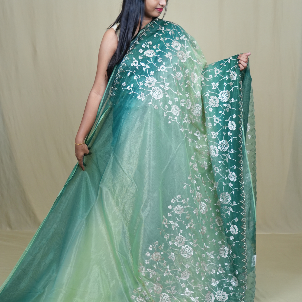 Elegant ethnic tissue saree featuring cutwork borders and graceful running pallu design.
