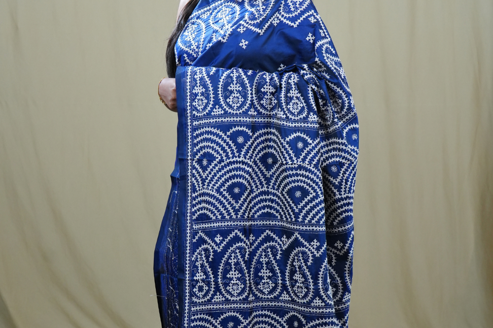 Traditional semi silk saree featuring beautiful hand Kutch work borders and artistic design.

