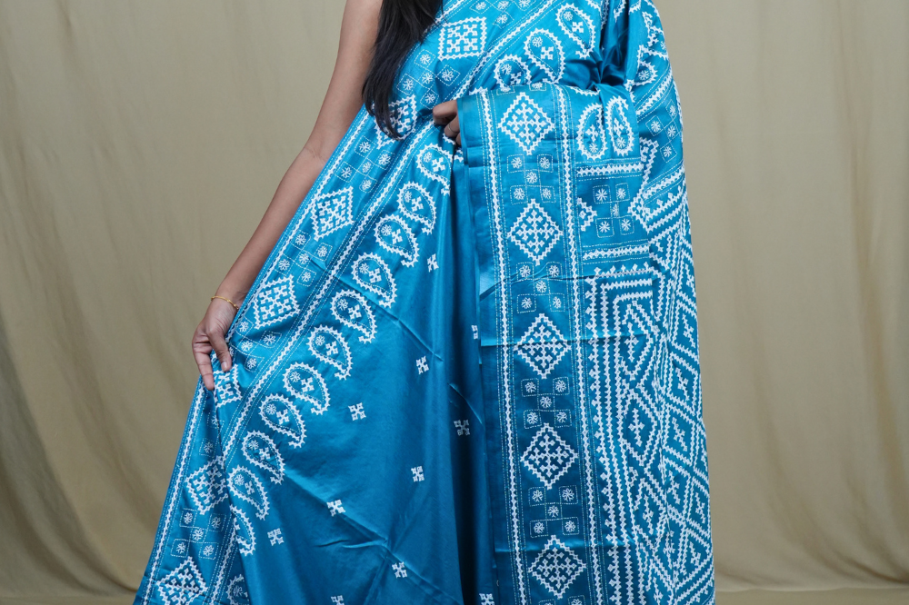 Semi Bangalore Silk Saree with all-over Kutch work motifs and rich embroidered pallu.
