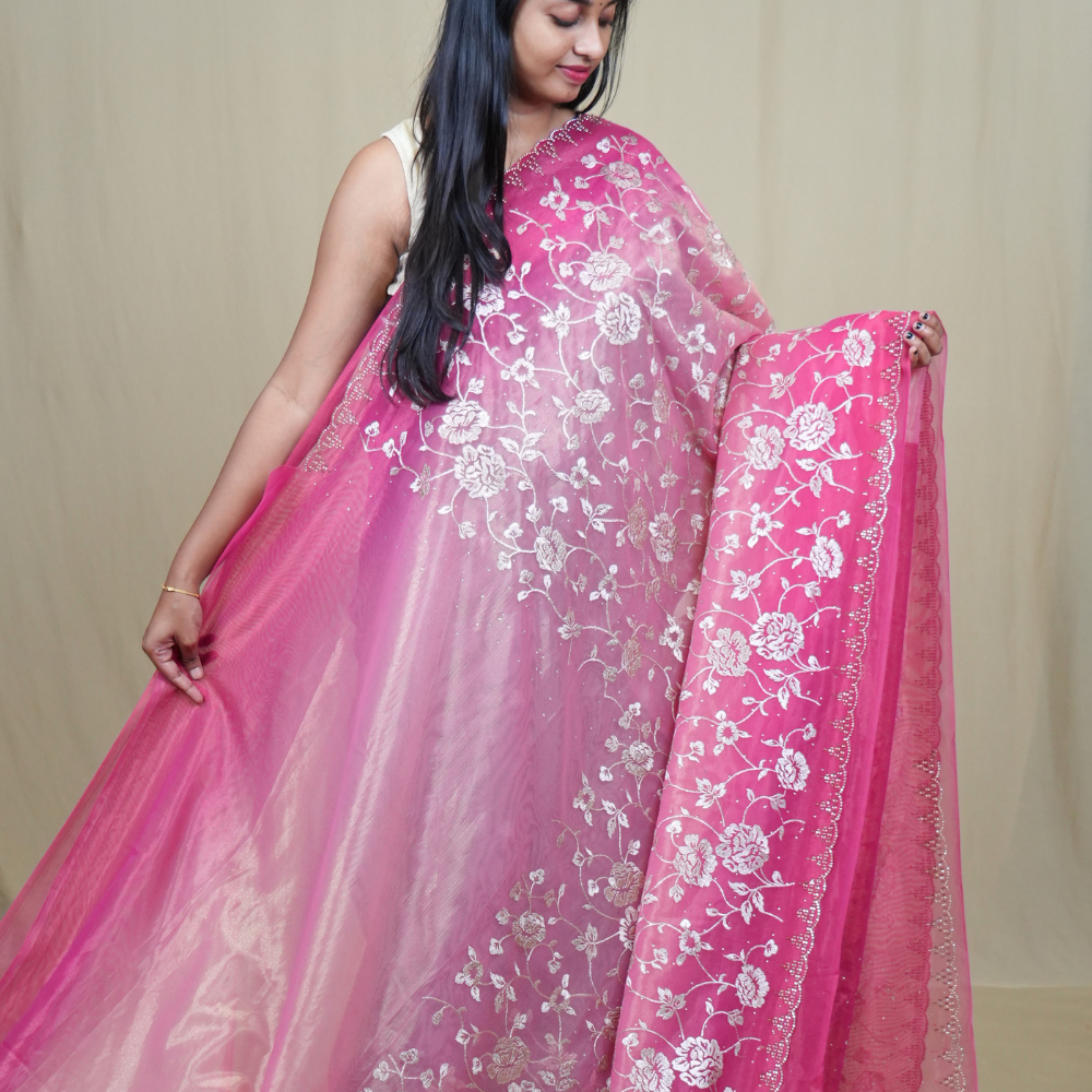 Elegant ethnic tissue saree featuring cutwork borders and graceful running pallu design.
