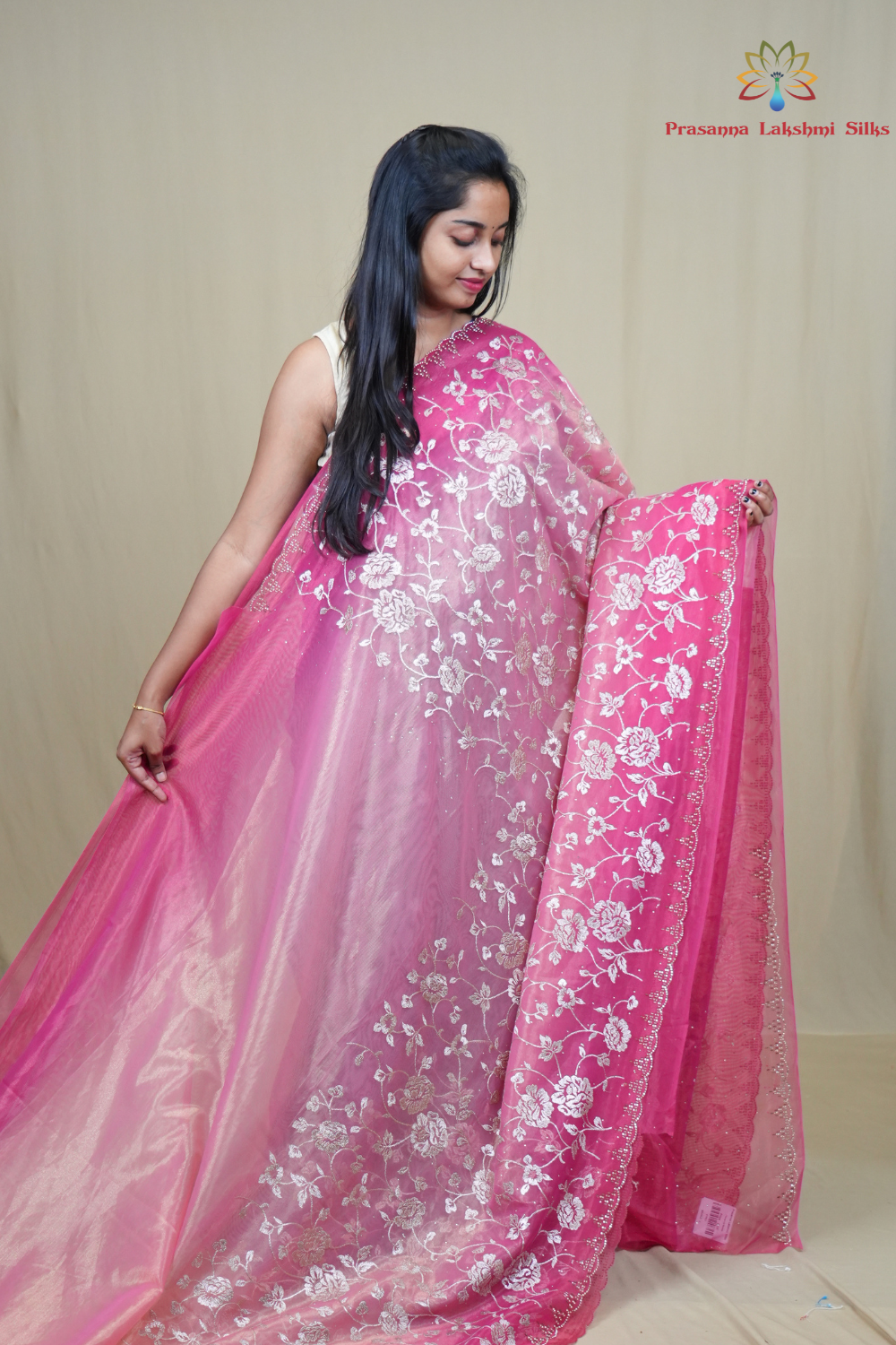 Elegant ethnic tissue saree featuring cutwork borders and graceful running pallu design.
