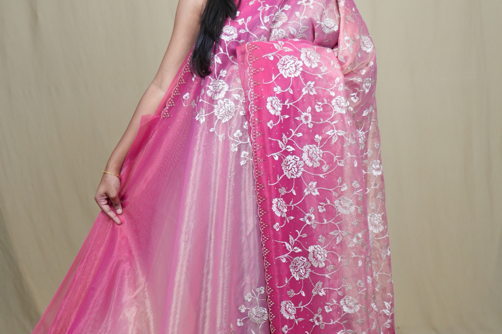Exquisite Tissue Net Saree with all-over silver zari floral embroidery and bead detailing.
