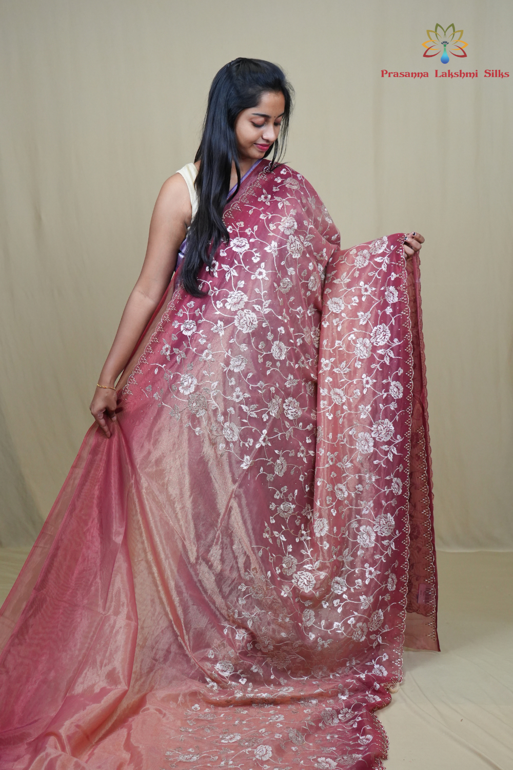 Elegant ethnic tissue saree featuring cutwork borders and graceful running pallu design.
