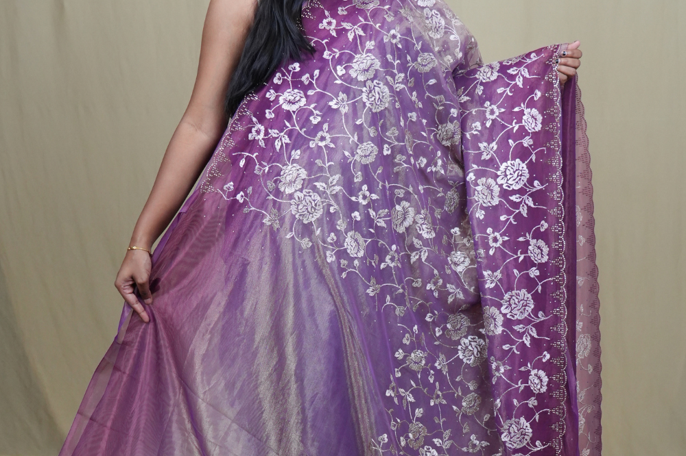Wedding guest tissue net saree paired with running blouse piece suitable for festive occasions.