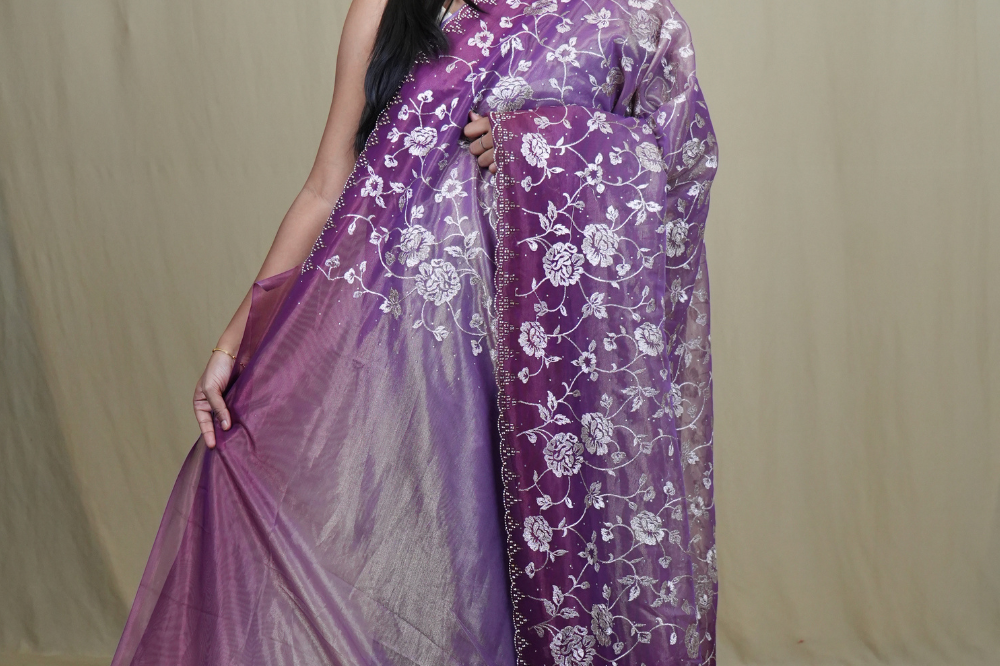 Exquisite Tissue Net Saree with all-over silver zari floral embroidery and bead detailing.
