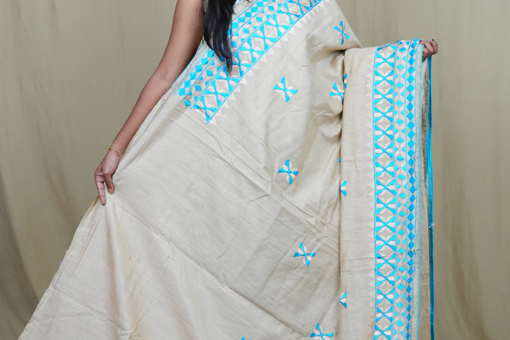 Elegant thread embroidered saree featuring rich pallu design and running blouse piece.
