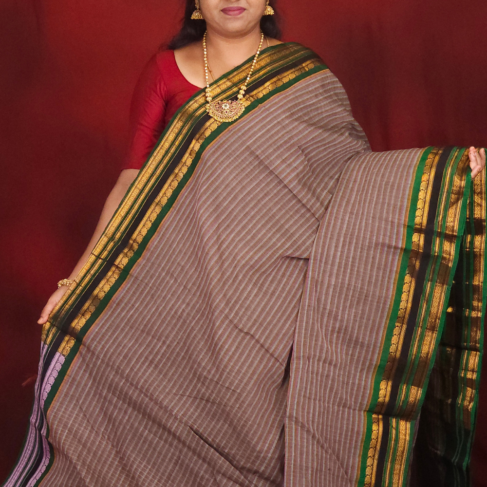 Lightweight Gadwal cotton saree featuring elegant zari border and striped pallu design.
