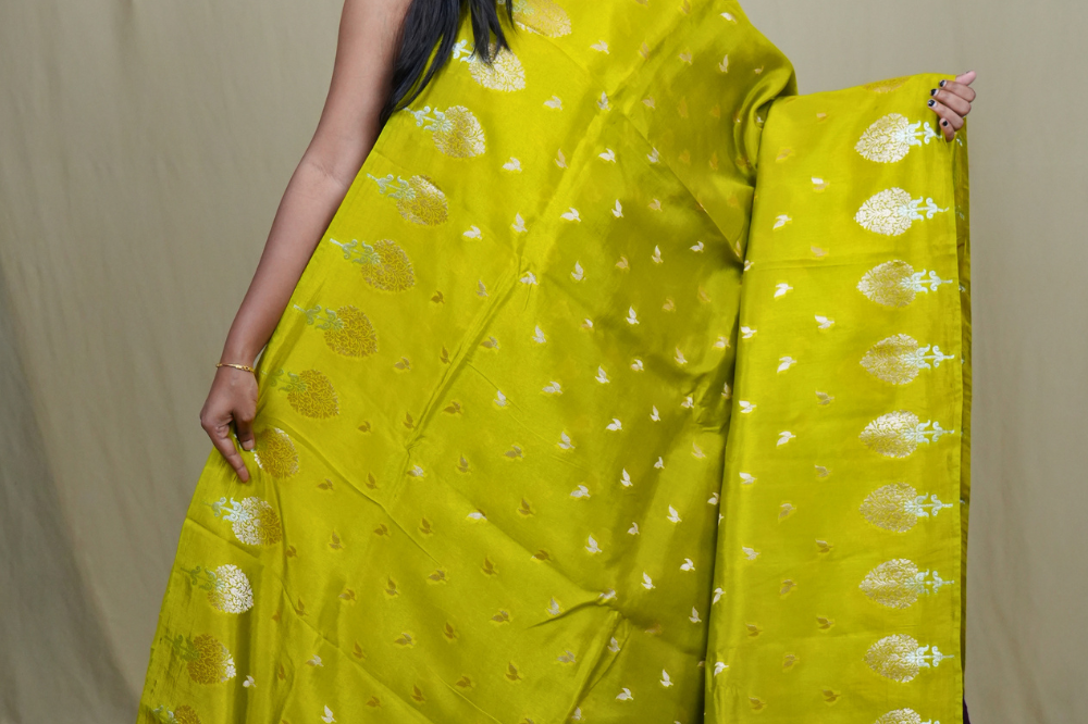 Traditional Banarasi silk saree featuring rich brocade pallu and matching brocade blouse.
