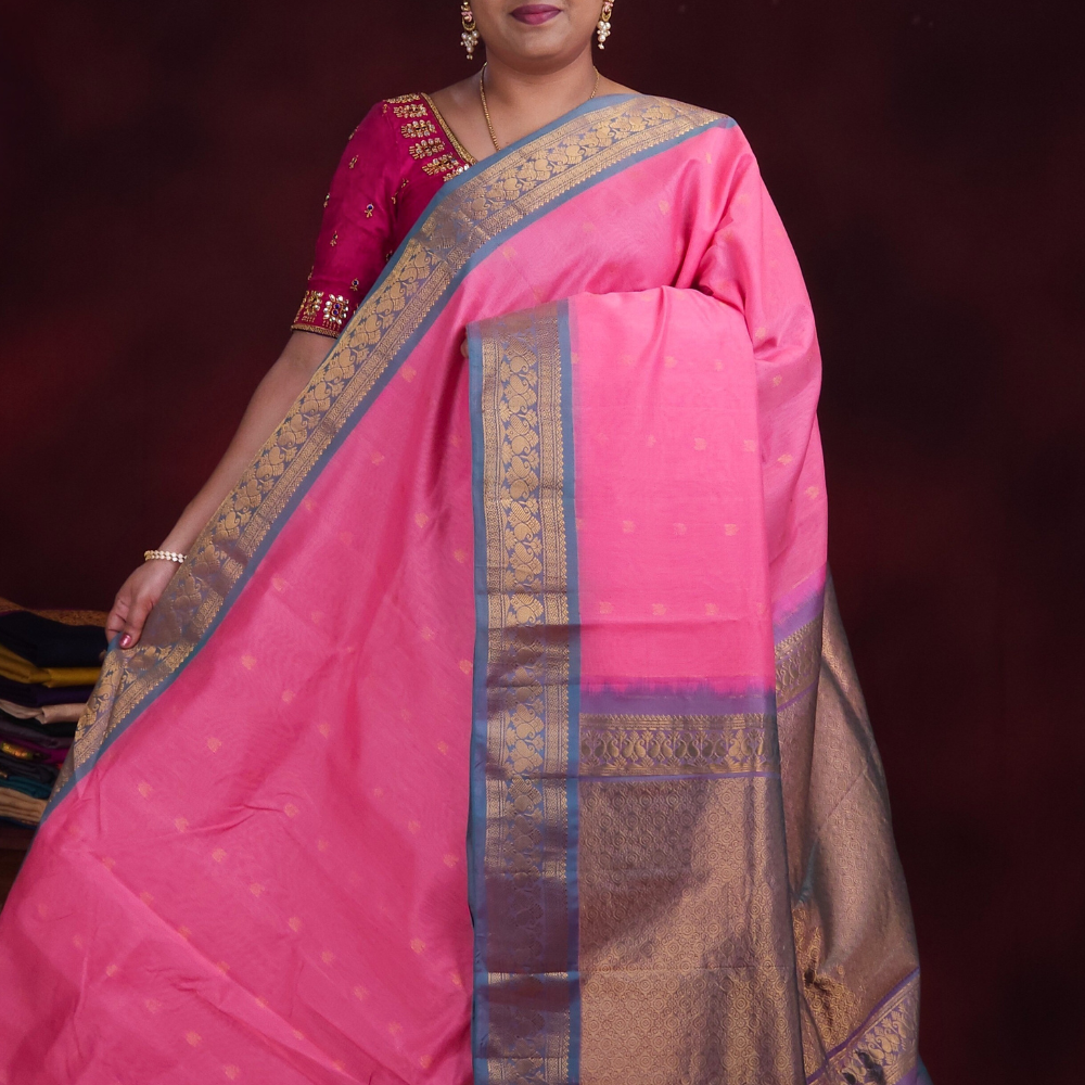 Baby pink Gadwal silk cotton saree with light teal green zari-woven border