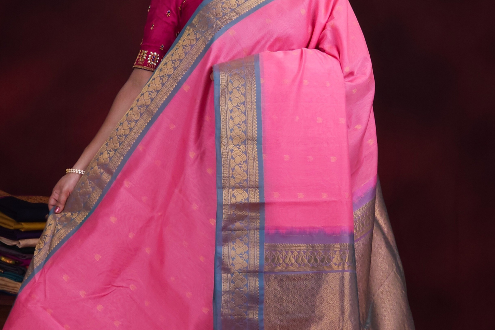 Baby pink Gadwal silk cotton saree with light teal green zari-woven border