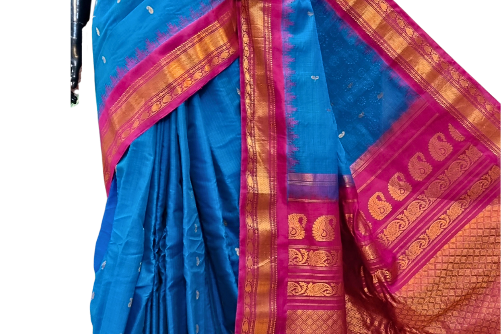 Handloom Gadwal silk cotton saree with all-over zari buttis and rich brocade pallu.
