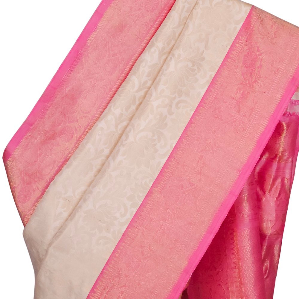 Close-up of gold zari brocade weave and baby pink border on a half white handloom Gadwal silk saree

