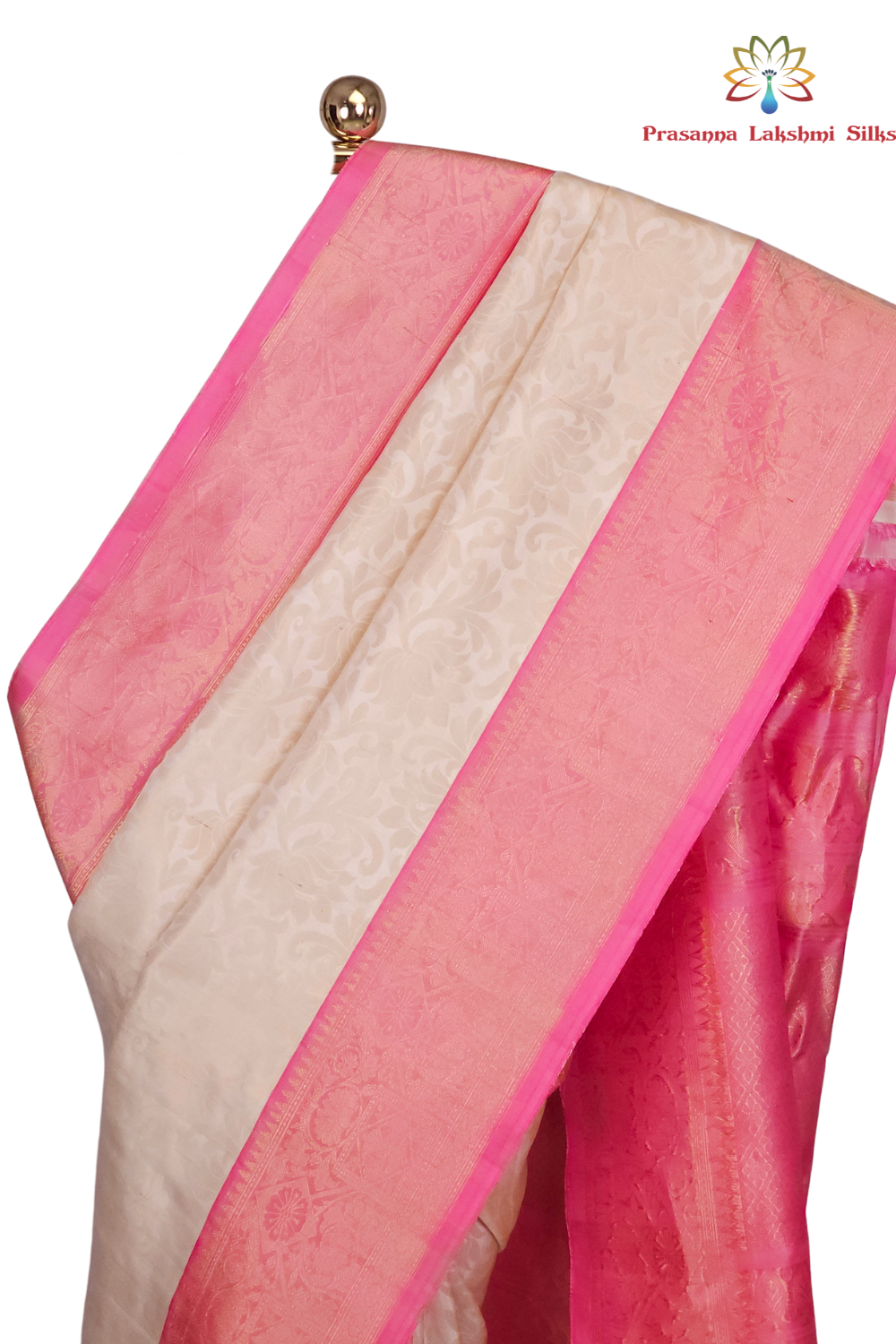 Close-up of gold zari brocade weave and baby pink border on a half white handloom Gadwal silk saree

