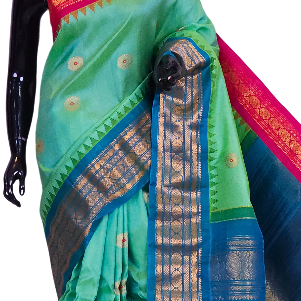 Close-up of the rich zari-woven brocade pallu on a handloom sea green pure silk Gadwal saree, highlighting the precise craftsmanship of the weave.