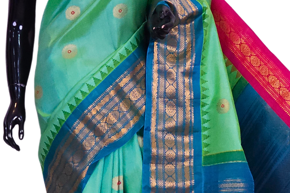Close-up of the rich zari-woven brocade pallu on a handloom sea green pure silk Gadwal saree, highlighting the precise craftsmanship of the weave.