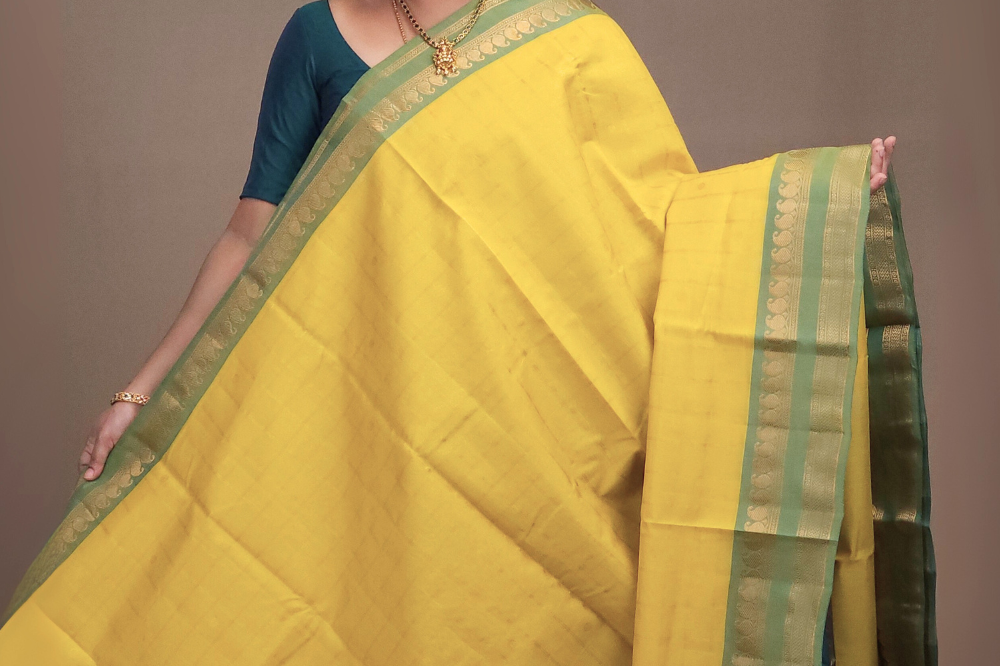 Close-up of zari checks and motifs on lime yellow Gadwal saree