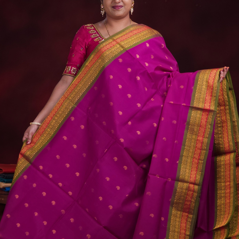 Close-up of zari motif detailing on deep magenta Gadwal saree