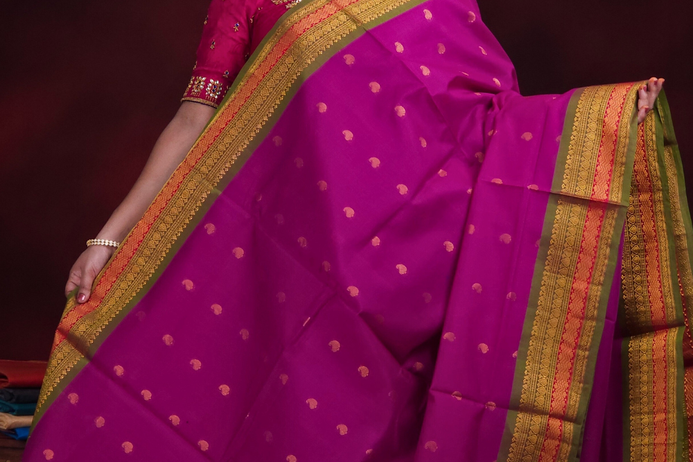 Close-up of zari motif detailing on deep magenta Gadwal saree