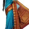 Handloom Gadwal silk cotton saree with all-over zari buttis and rich brocade pallu.
