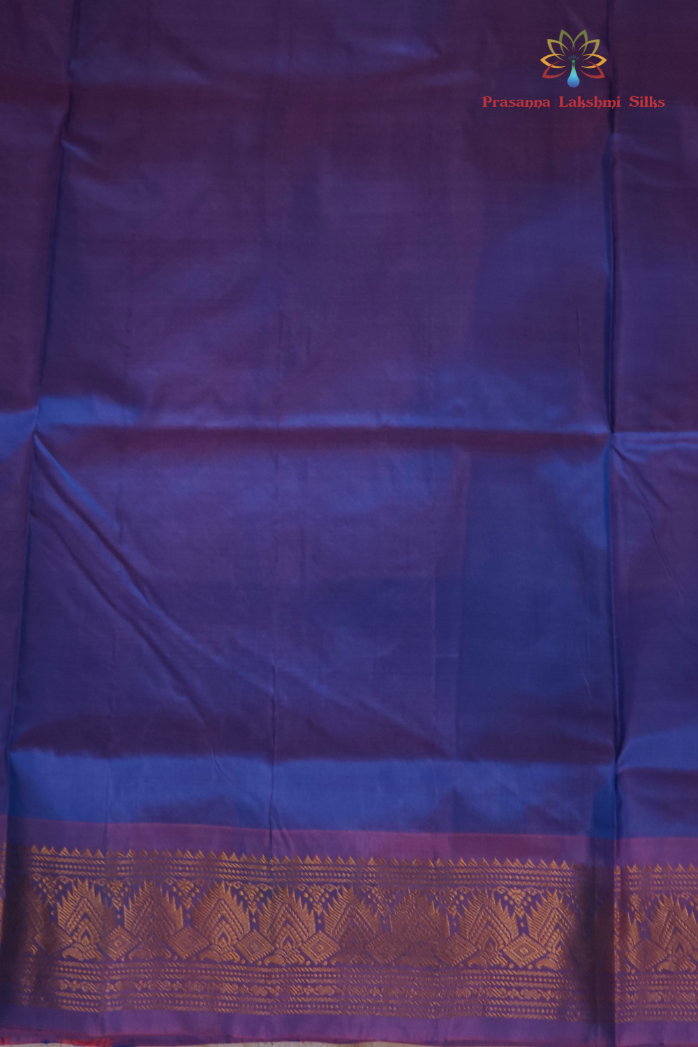 Copper sulphate blue and lilac Gadwal saree draped, showing brocade pallu and lilac blouse