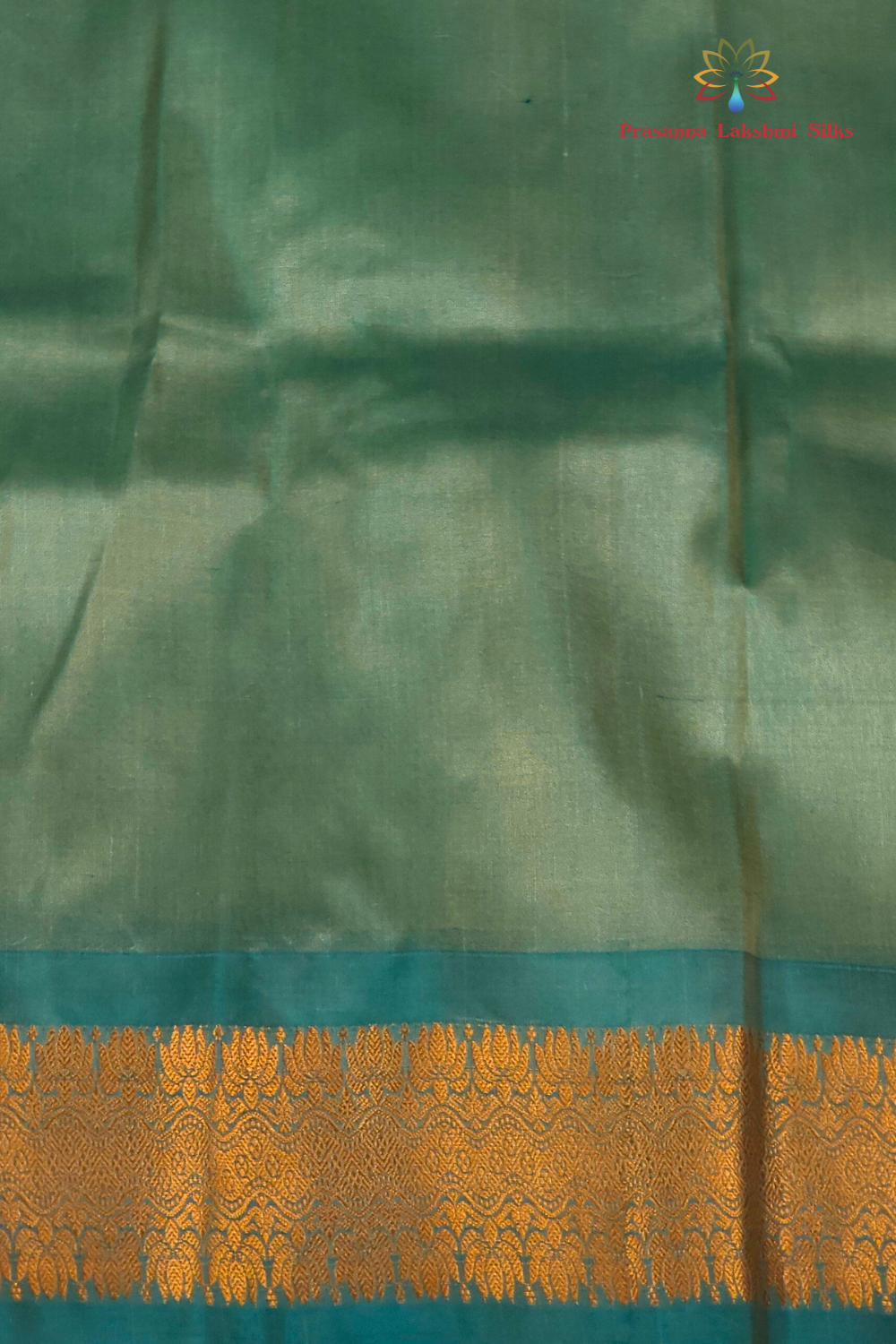Cream Gadwal saree draped, showing brocade pallu and Light Sea Green blouse