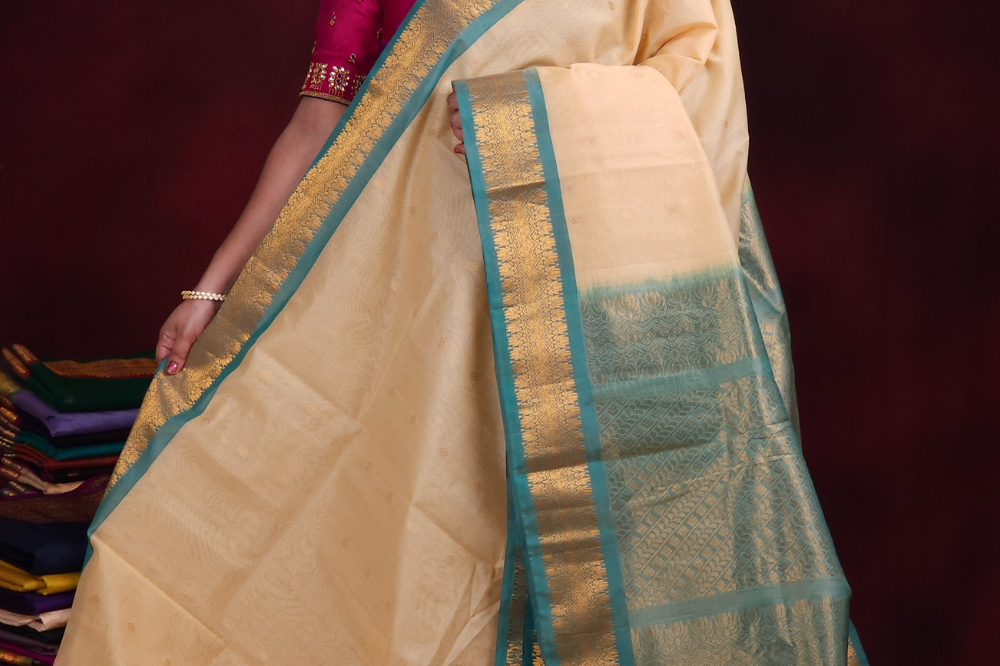 Cream Gadwal silk cotton saree with Light Sea Green zari-woven border
