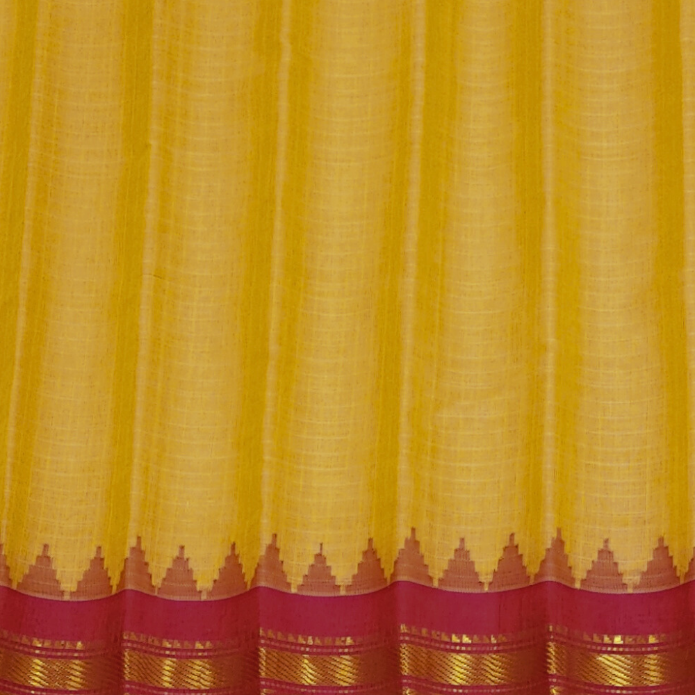 Cream and pink handloom Gadwal saree draped, showing blouse piece and zari detailing