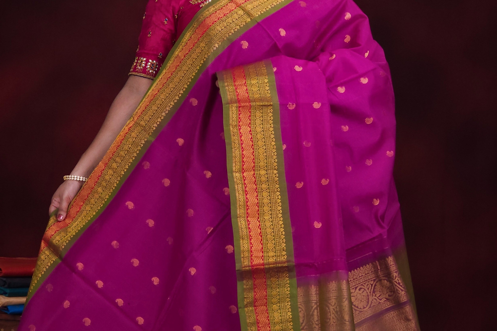 Deep magenta Gadwal silk cotton saree with olive green zari-woven border