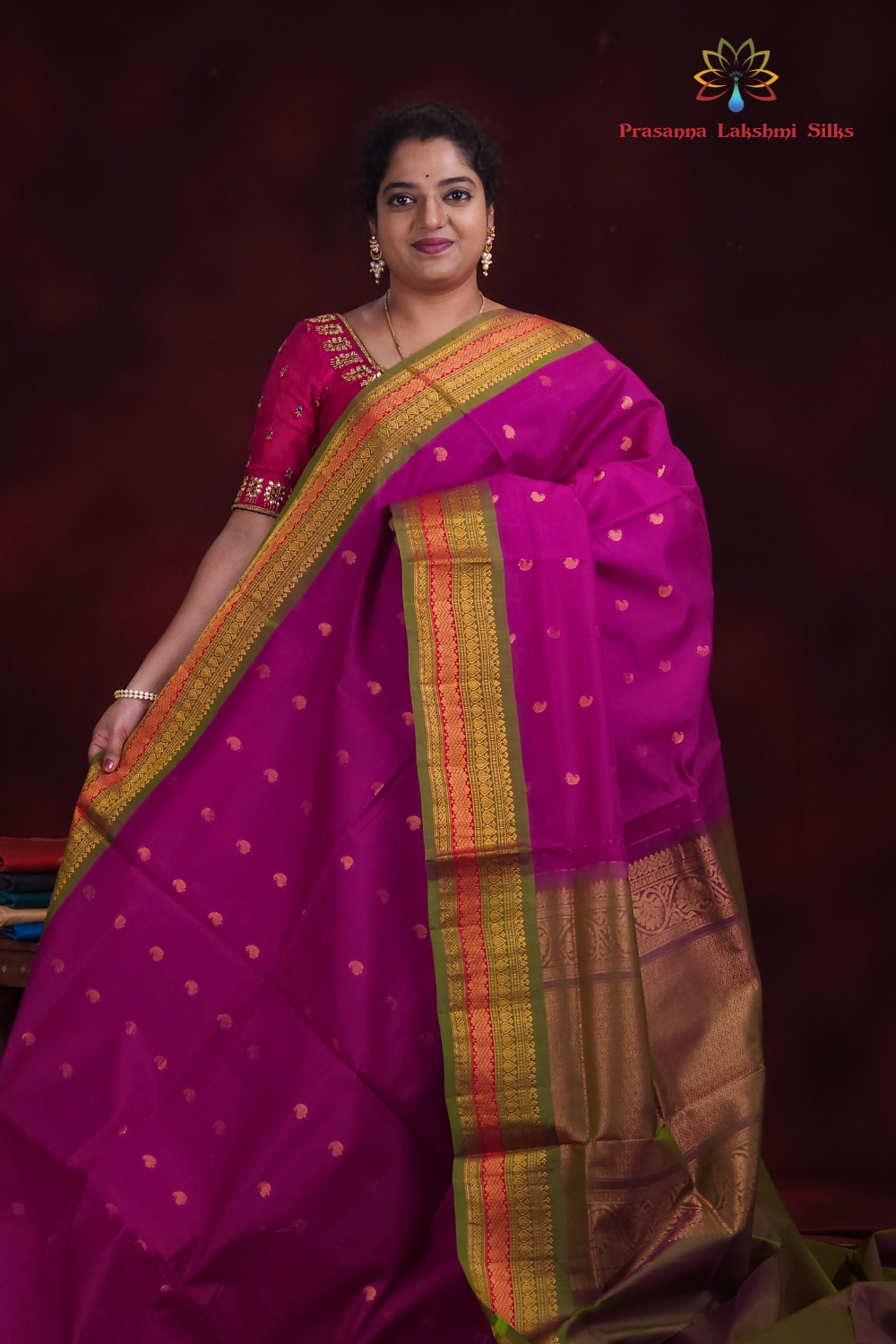 Deep magenta Gadwal silk cotton saree with olive green zari-woven border