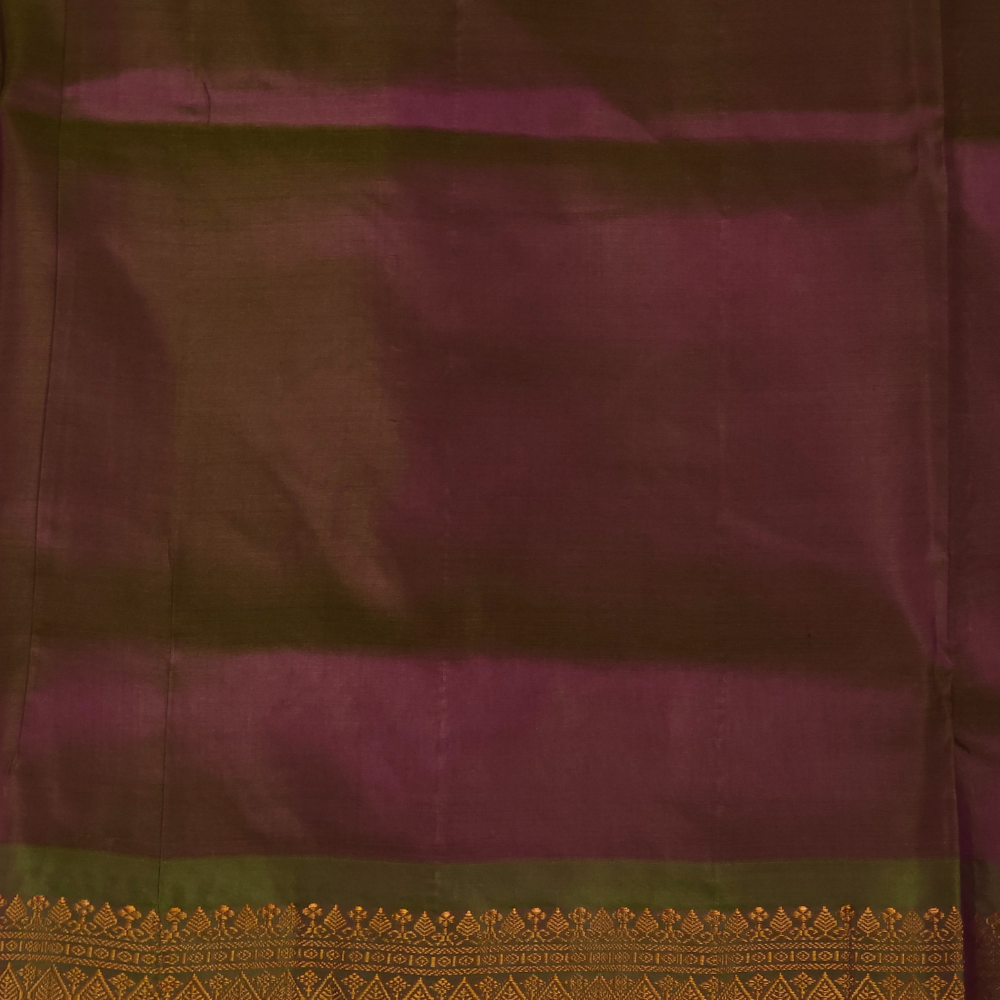 Deep magenta and olive green Gadwal saree draped, showing brocade pallu and olive green blouse