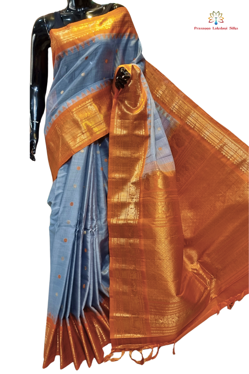 Handloom Gadwal silk cotton saree with all-over zari buttis and rich brocade pallu.
