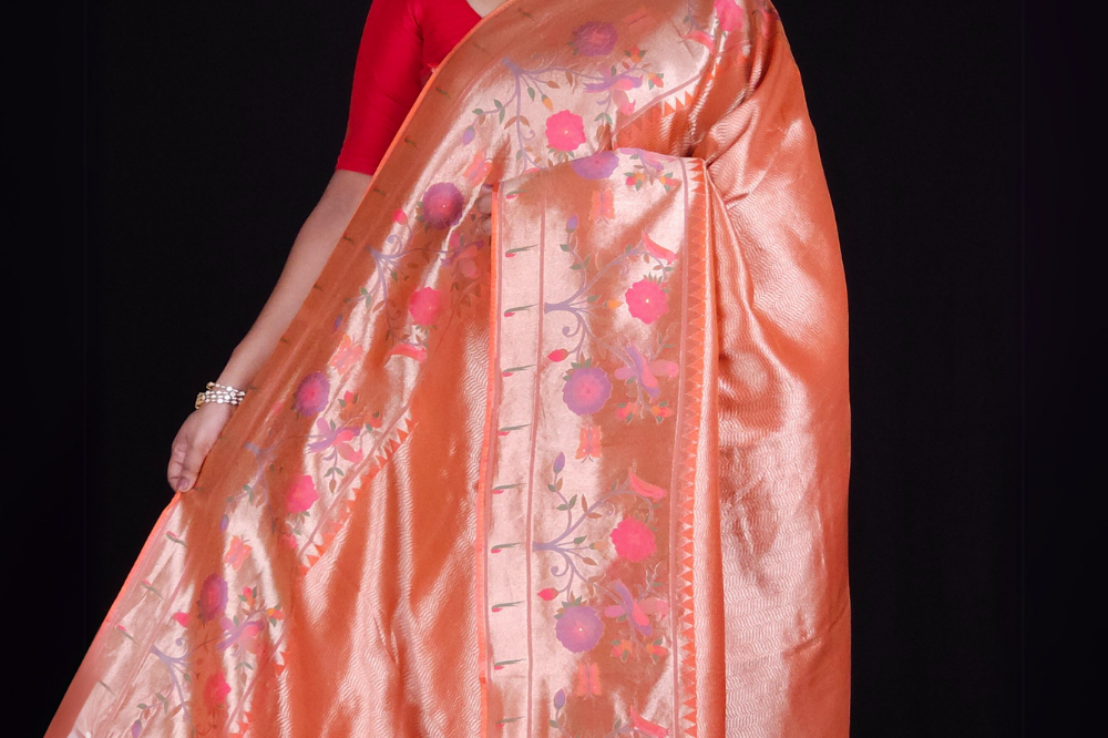 ''Orange tissue saree with floral pallu and running blouse"