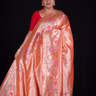 ''Orange tissue saree with floral pallu and running blouse"