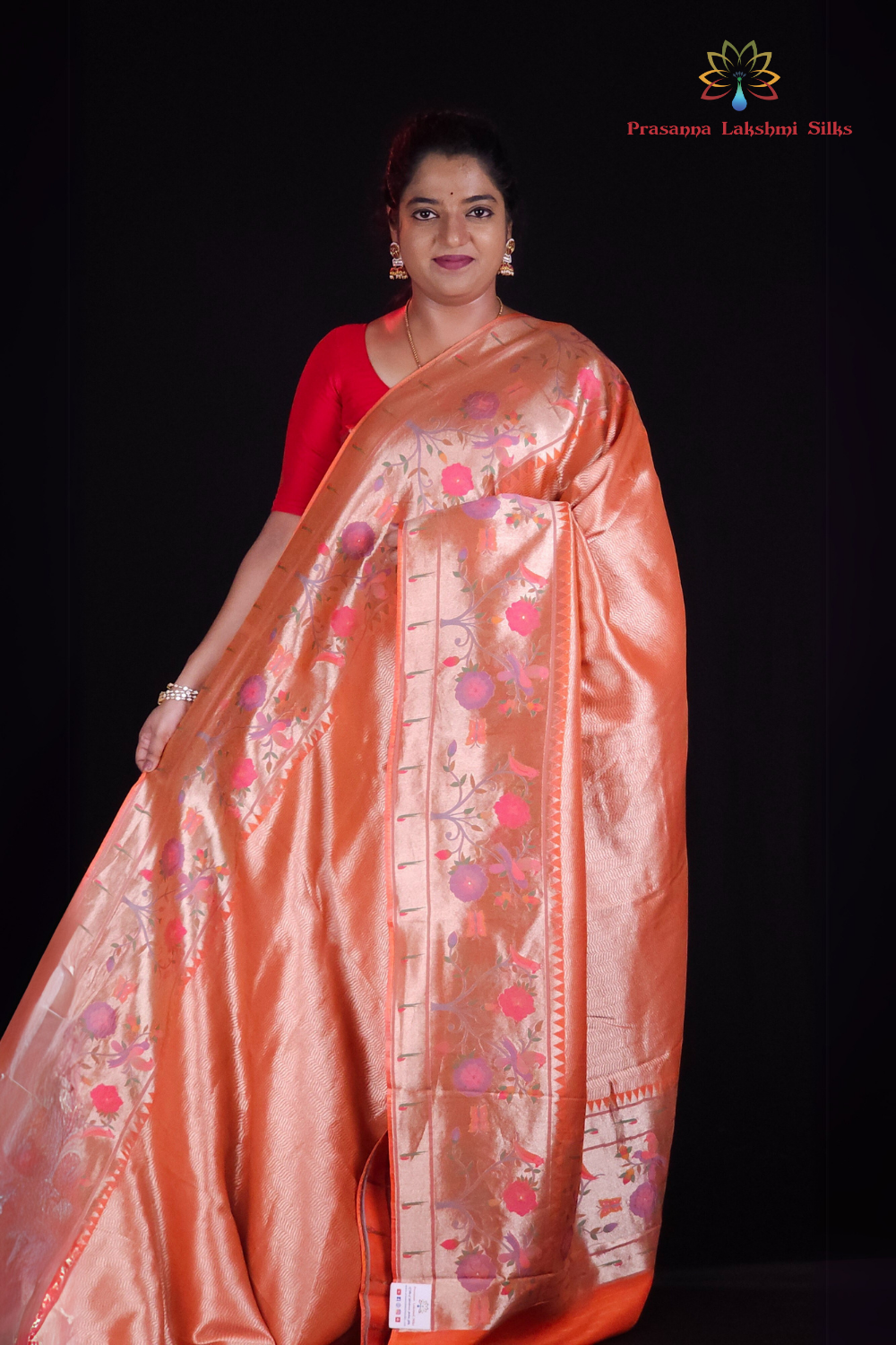 ''Orange tissue saree with floral pallu and running blouse"